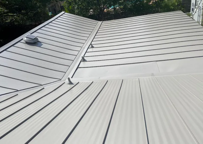 Solar attic fan installed on a metal roof for Roof Ventilation in Maywood